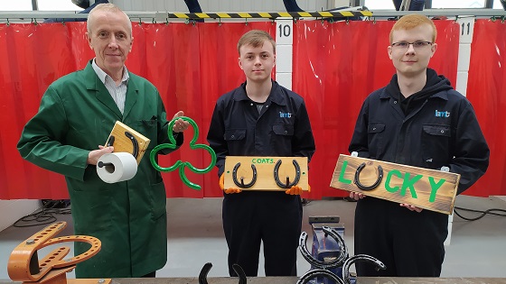 Engineering staff and students with horseshoe products